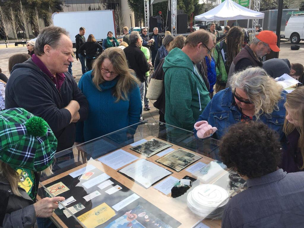 People examine artifacts retrieved from a time capsule buried in 1968 during a ceremony staged by Santa Rosa City 150 on Saturday, March 17, 2018 in Old Courthouse Square. (SANTA ROSA CITY 150 FACEBOOK PAGE).