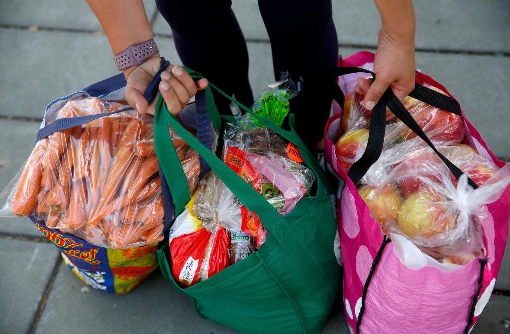 Bags filled with food donated through the Redwood Empire Food Bank in 2018. (Beth Schlanker/ The Press Democrat)