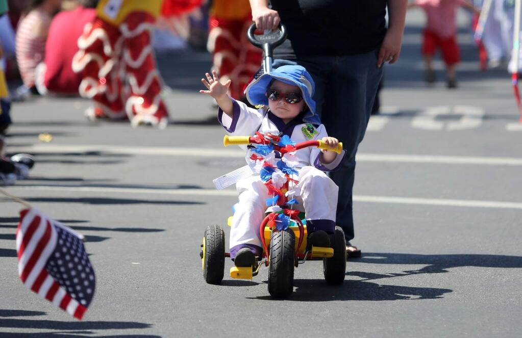 William Jackson, 3, waves to the crowd during the Fourth of July Parade and Plaza celebration in Sonoma, July 4, 2012.