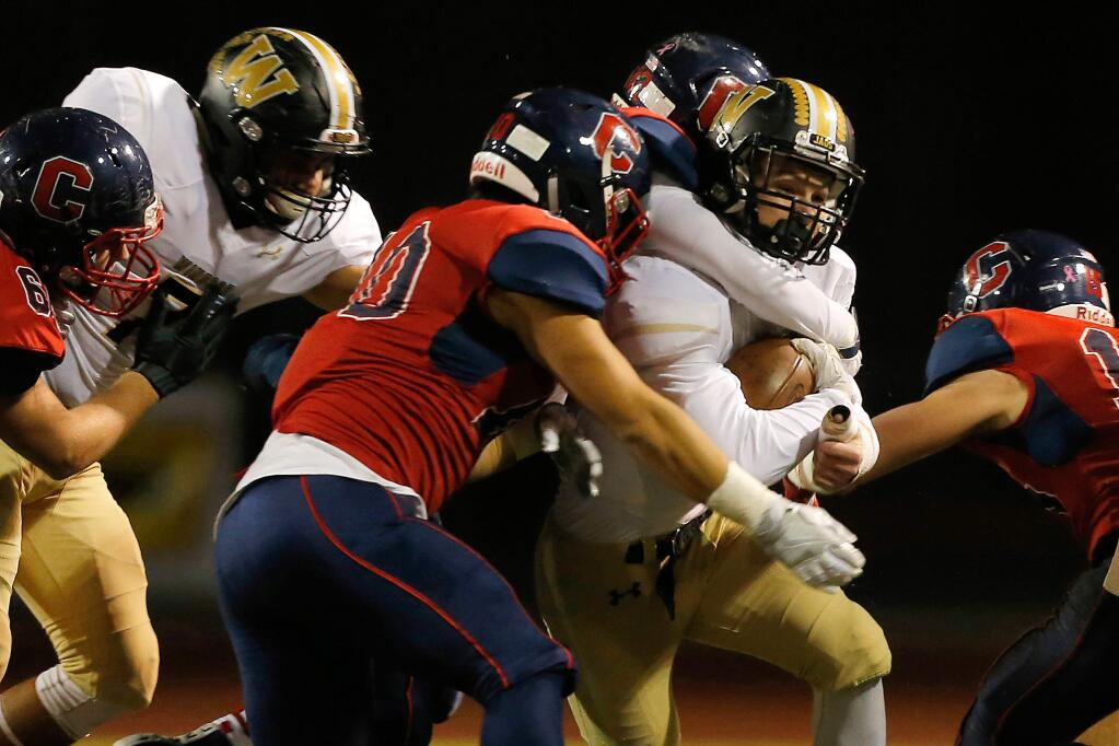 Windsor's Jackson Baughman (8), second from right, gets tackled by Campolindo's Brandon Bocobo (10), center, and Grant Larsen (42) during first half of the NCS Division 2 championship football game between Windsor and Campolindo high schools at Diablo Valley College in Pleasant Hill, California, on Friday, December 2, 2016. (Alvin Jornada / The Press Democrat)