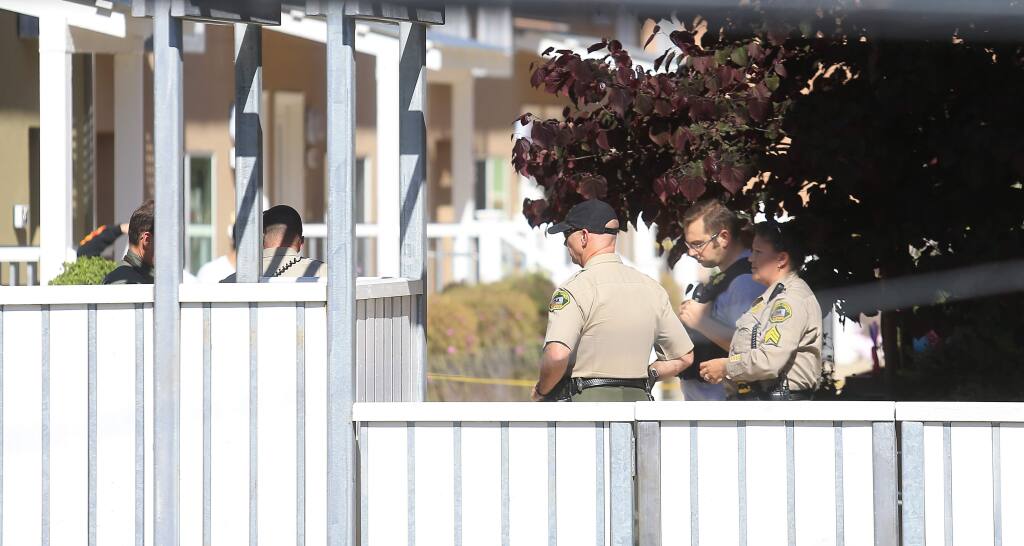 Sonoma County deputies and a CHP officer secure the scene of a deputy-involved shooting at Fife Creek Commons in Guerneville on Wednesday April 29, 2015. (KENT PORTER/ PD)