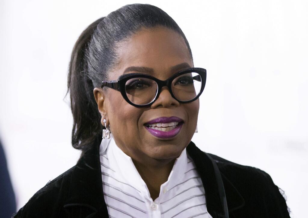 FILE - In this Oct. 21, 2017 file photo, Oprah Winfrey arrives for the David Foster Foundation 30th Anniversary Miracle Gala and Concert, in Vancouver, British Columbia. (Darryl Dyck/The Canadian Press via AP, File)