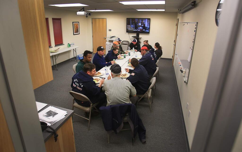 GATHERED AT THE TABLE: Bodega Volunteer Fire Co. firefighters eat dinner after a training session on in Bodega.