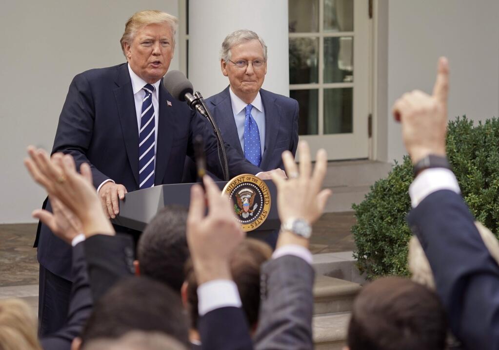 Journalist raise their hands as they wait to called on to ask a question to President Donald Trump and Senate Majority Leader Mitch McConnell of Ky., in the Rose Garden of the White House, Monday, Oct. 16, 2017. (AP Photo/Pablo Martinez Monsivais)