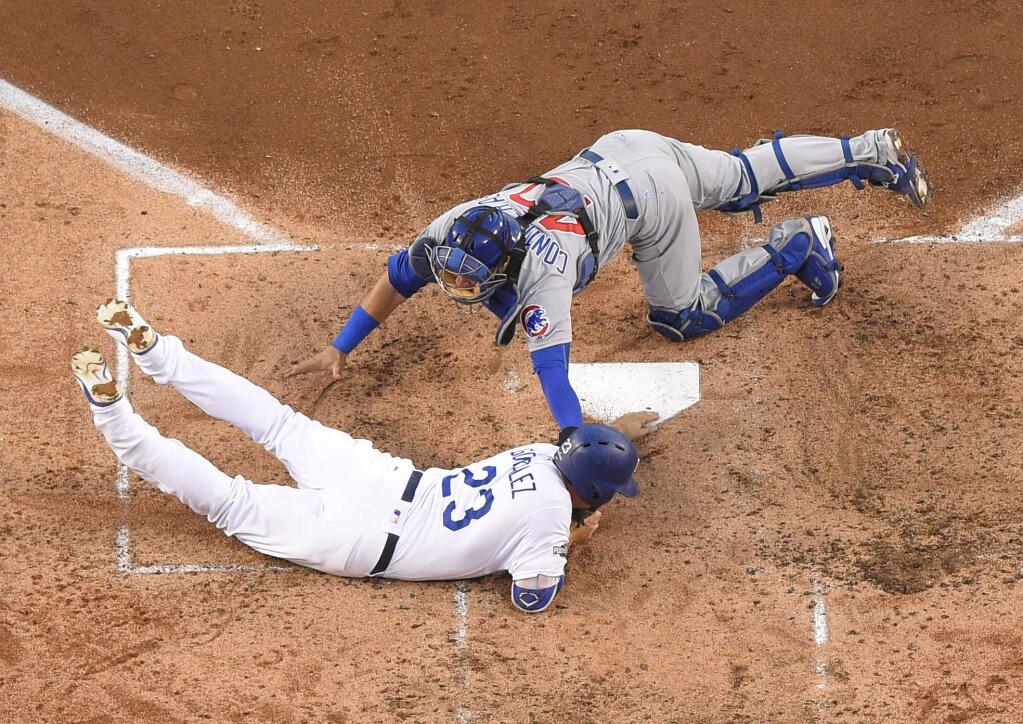 Chicago Cubs catcher Willson Contreras tags out Los Angeles Dodgers' Adrian Gonzalez at home during the second inning of Game 4 of the National League baseball championship series Wednesday, Oct. 19, 2016, in Los Angeles. Gonzalez tried to score from second on a hit by Andrew Toles. (AP Photo/Mark J. Terrill)