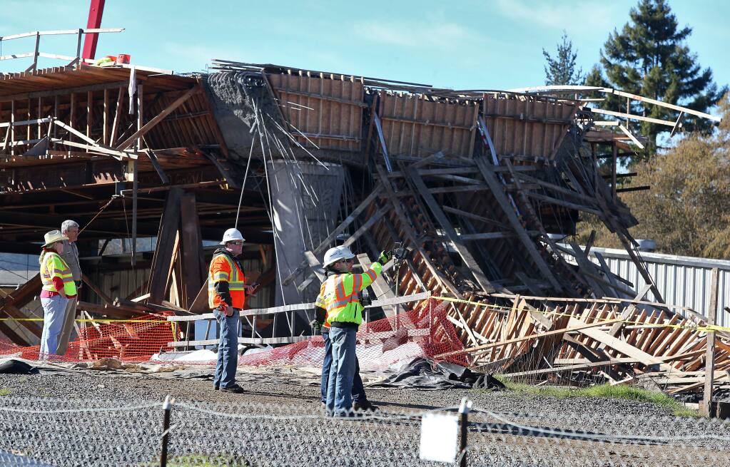 CalTrans and construction personnel view the bypass bridge collapse in Willits on Friday, January 23, 2015. (Christopher Chung/ The Press Democrat)