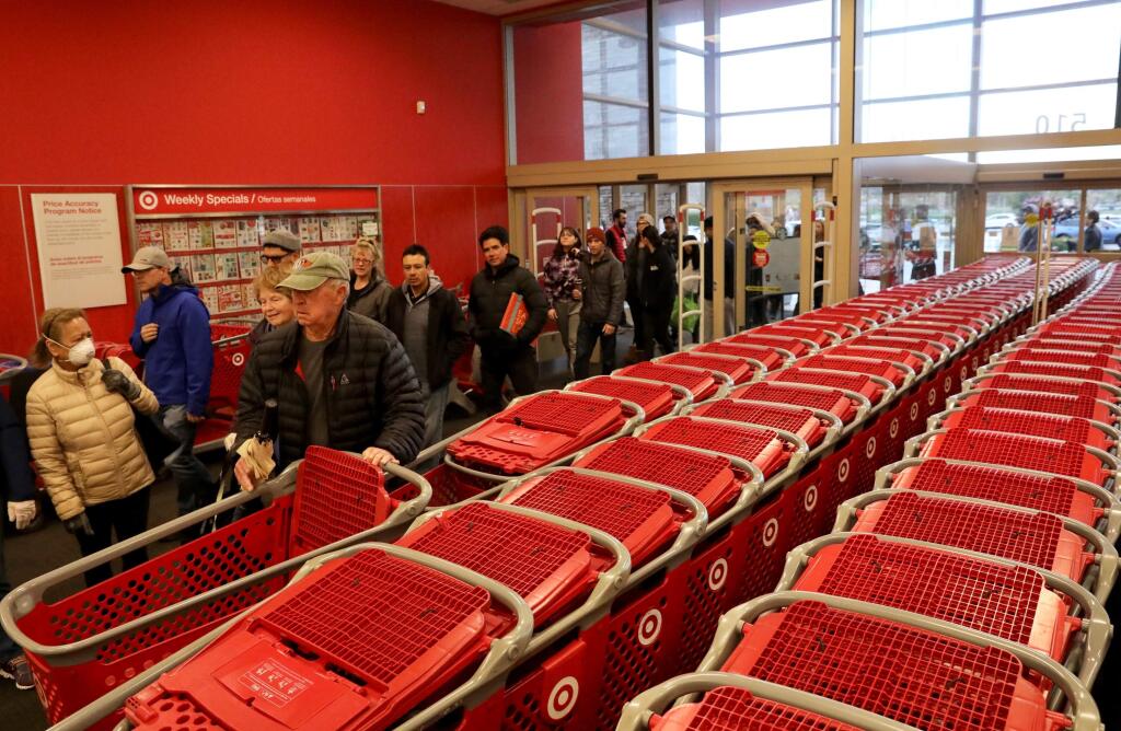 Customers stream into Target in Petaluma when the doors open on Wednesday, March 18, 2020. (Beth Schlanker/The Press Democrat)