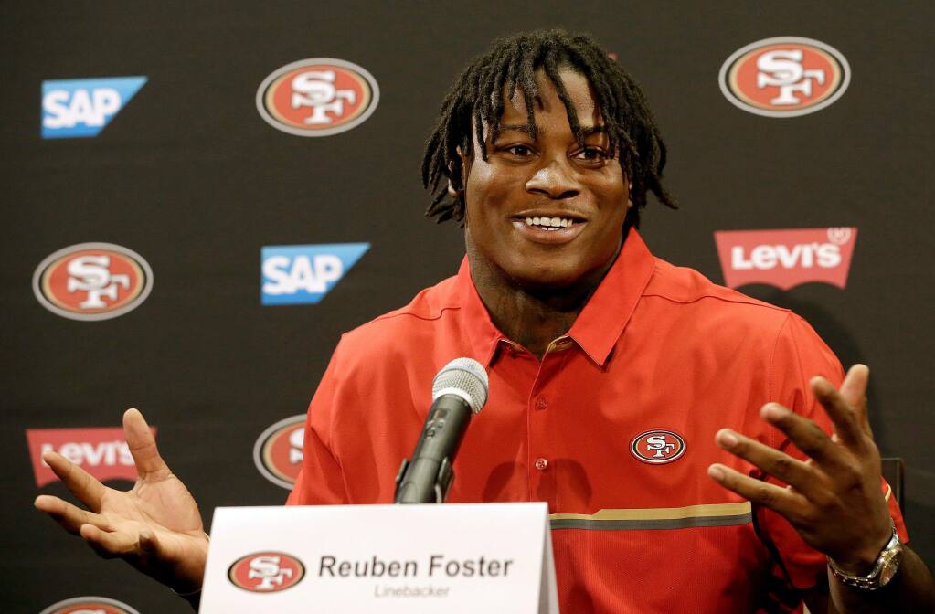 FILE - In this April 28, 2017, file photo, San Francisco 49ers draft pick Reuben Foster answers questions at a news conference in Santa Clara, Calif. Authorities say San Francisco 49ers linebacker Reuben Foster has been charged with felony domestic violence after being accused of attacking his girlfriend. The Santa Clara County District Attorney says Foster was charged Thursday, April 12, 2018, and is scheduled to be arraigned later in the day in San Jose. Prosecutors say the 24-year-old Foster attacked his girlfriend in February at their Los Gatos home, leaving her bruised and with a ruptured ear drum. (AP Photo/Jeff Chiu, File)