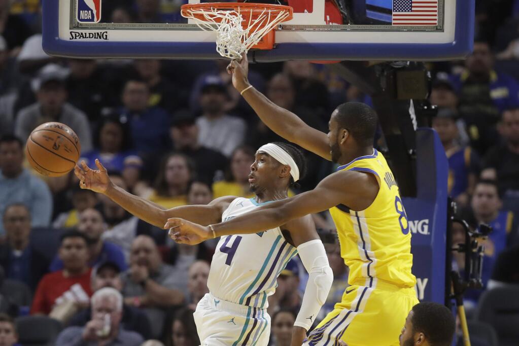 Charlotte Hornets guard Devonte' Graham passes the ball as he is defended by Golden State Warriors guard Alec Burks during the second half in San Francisco, Saturday, Nov. 2, 2019. (AP Photo/Jeff Chiu)