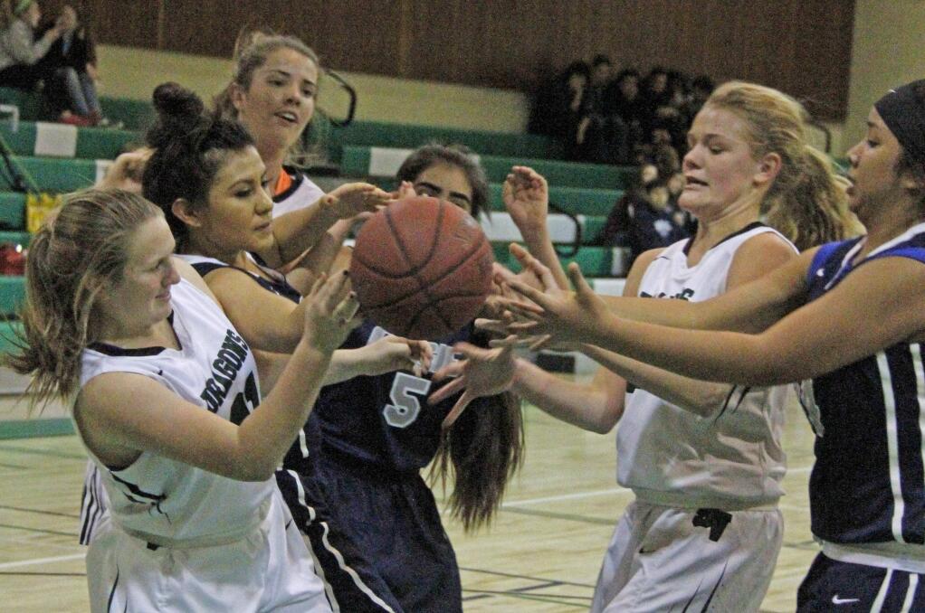 Bill Hoban/Index-TribuneSonoma's Annie Neles, left, and Grace Cutting, second from right, find themselves in a scrum for a loose ball in Friday night's game against Elsie Allen. The Lady Dragons beat Elsie Allen 49-3 in a lopsided affair.