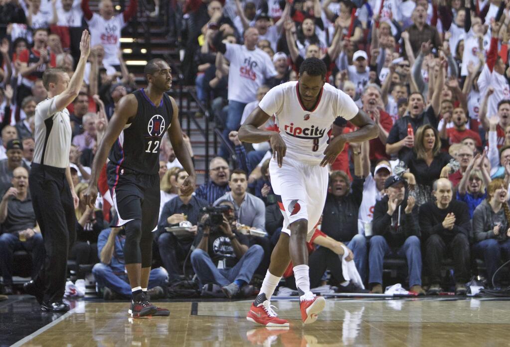 Portland Trail Blazers forward Al-Farouq Aminu, right, reacts after making a three point basket over Los Angeles Clippers forward Luc Richard Mbah a Moute, left, during the first half of Game 4 of an NBA basketball first-round playoff series Monday, April 25, 2016, in Portland, Ore. (AP Photo/Craig Mitchelldyer)