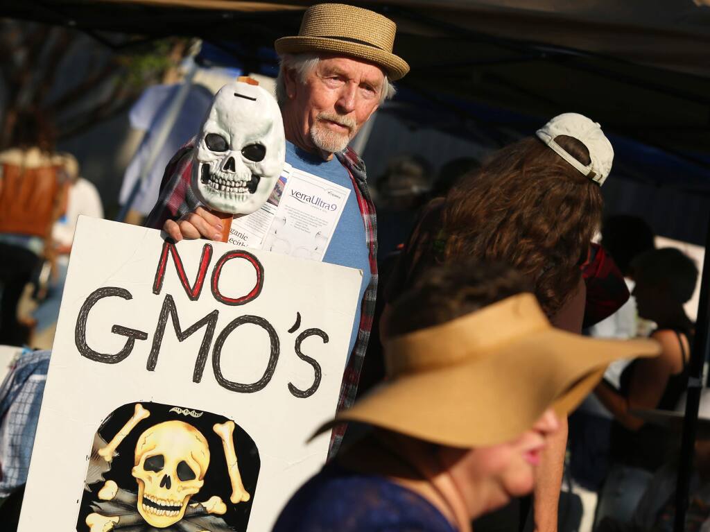 Loren Faber of Forrestville protests against use of genetically modified organisms (GMOs) and agro-chemicals during the Global 'March Against Monsanto outside Santa Rosa City Hall on Saturday, October 12, 2013. (Conner Jay/The Press Democrat)
