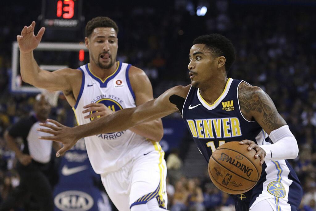 The Denver Nuggets' Gary Harris, right, drives the ball against the Golden State Warriors' Klay Thompson during the first half of a preseason game Saturday, Sept. 30, 2017, in Oakland. (AP Photo/Ben Margot)
