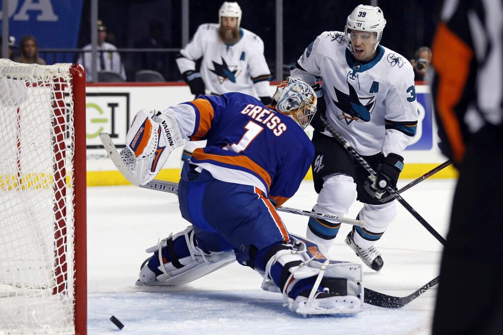 San Jose Sharks' Logan Couture (39) scores his third goal of the game past New York Islanders goalie Thomas Greiss in the third period Saturday, Oct. 21, 2017, in New York. The Islanders won 5-3. (AP Photo/Adam Hunger)