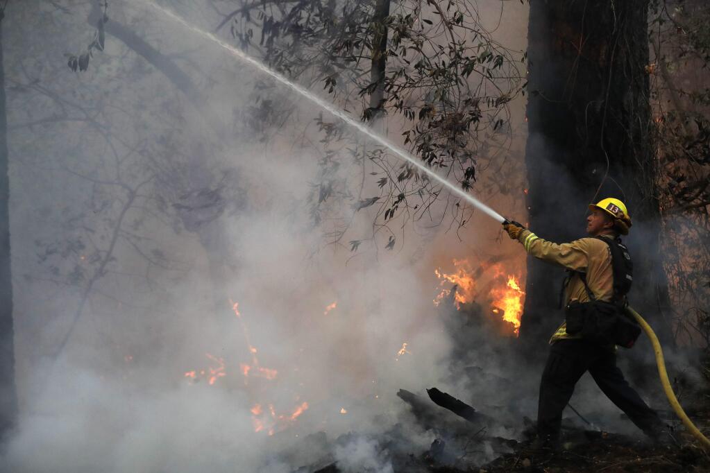 Burbank firefighter Ruben Mercado fights flames during the Wine Country wildfires in October. (MARCIO JOSE SANCHEZ / Associated Press)