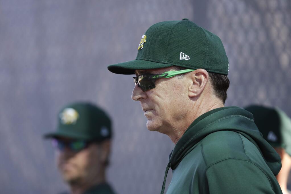 Oakland Athletics manager Bob Melvin watches as pitchers throw during spring training, Wednesday, Feb. 12, 2020, in Mesa, Ariz. (AP Photo/Darron Cummings)
