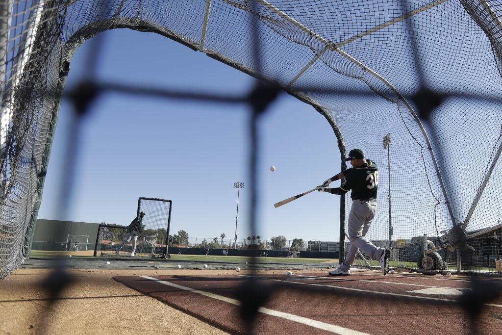 The Oakland Athletics' Austin Allen hits during spring training, Thursday, Feb. 13, 2020, in Mesa, Ariz. (AP Photo/Darron Cummings)