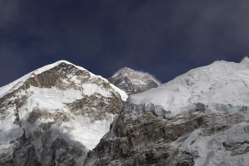FILE - In this March 7, 2016 file photo, Mt. Everest, in middle, altitude 8,848 meters (29,028 feet), is seen on the way to base camp. (AP Photo/Tashi Sherpa, File)