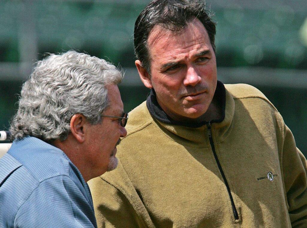 Brian Sabean of the Giants, left, and Billy Beane of the A's are the senior general managers among the Bay Area's professional sports teams. Both men were elevated to general manager in 1997. (Eric Risberg / Associated Press)