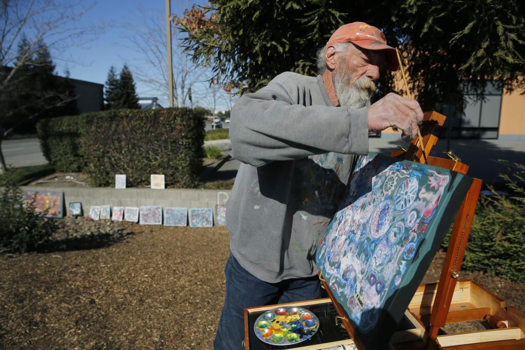 Homeless artist Michael Koerber known as the 'Local Hobo' works on a painting on the 600 block Payran St on Thursday, February 22, 2018 in Petaluma, California . (BETH SCHLANKER/The Press Democrat)