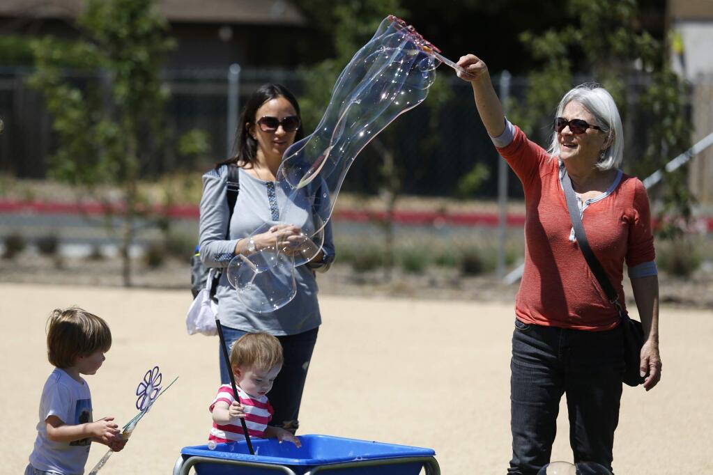 Jeanie Harmon, right, and her daughter Laurel Jabbar, her granddaughter, Aminah Jabbar, 15-months, and Wesson Balser, 23-months play with bubbles at the Children's Museum of Sonoma County. (BETH SCHLANKER/ The Press Democrat, file)