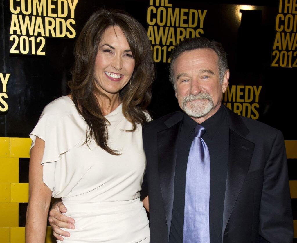 FILE - In this April 28, 2013 file photo, Robin Williams, right, and his wife Susan Schneider Williams arrive to The 2012 Comedy Awards in New York. Schneider wrote an essay published in the medical journal, 'Neurology,' on Sept. 27, 2016, that Williams had 'chemical warfare in his brain‚Äù before his death. (AP Photo/Charles Sykes, File)