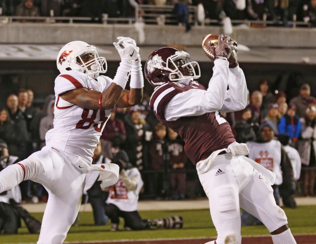 Mississippi State defensive back Will Redmond (2) reaches to intercept a pass intended for Arkansas wide receiver Demetrius Wilson (85) in the end zone in the final seconds of the second half Saturday, Nov. 1, 2014. Mississippi State won 17-10. (AP Photo/Rogelio V. Solis)