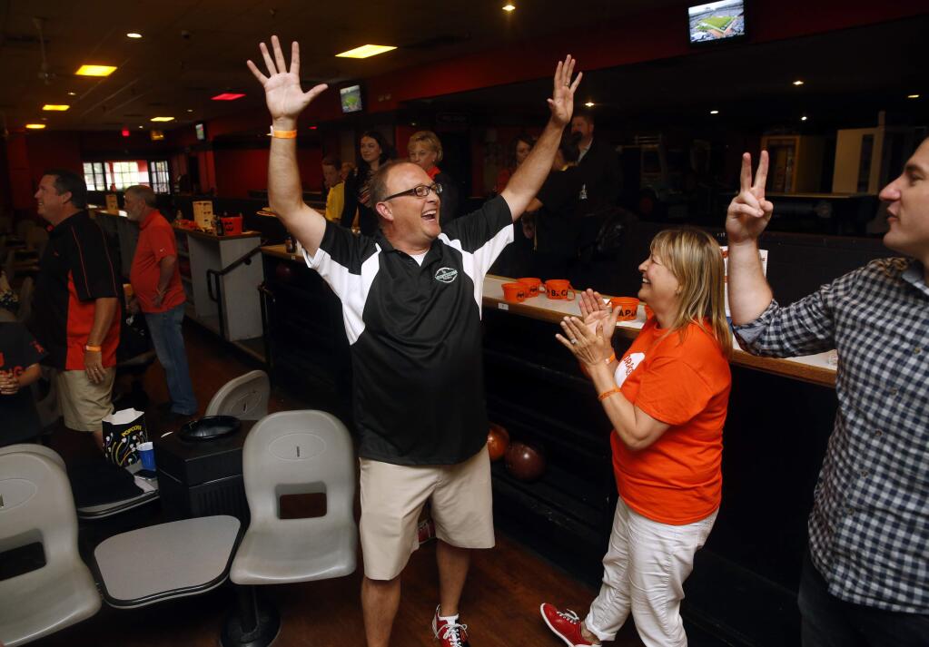Scott Kerr reacts after getting a strike and winning a commemorative bowling pin during a fundraiser honoring C.J. Banaszek for the Alex's Lemonade Stand Foundation at the AMF Boulevard Lanes on Sunday, October 16, 2016 in Petaluma, California . (BETH SCHLANKER/ The Press Democrat)