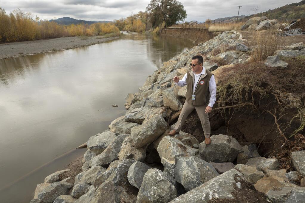 Sonoma County Director of Transportation & Public Works, Johannes Hoevertsz stands on a wall of erosion control rocks on the Russian River near Geyserville. Gravel has shifted the Russian River taking out portions of a vineyard and threatening damage to River Rd. (photo by John Burgess/The Press Democrat)