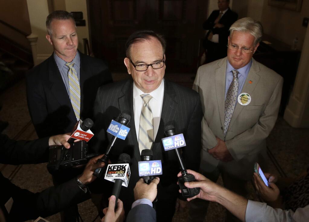FILE-This Aug. 13, 2014 file photo shows California Senate Minority Leader Bob Huff, R-Diamond Bar, center, accompanied by GOP Sens. Anthony Canella, of Ceres, left, and Andy Vidak, of Hanford, talks during a news conference in Sacramento, Calif. California Republicans made a strategic decision to focus their limited money and campaign networks on a handful of state legislative races to block Democrats from gaining a supermajority and build a team for the future. Trying a more ambitious approach to break the Democrats stranglehold on the statewide offices was deemed too expensive and too likely to end in defeat, given Democrats large edge in voter registration. That strategy paid off Tuesday, Nov. 4 when the minority party protected their most competitive legislative races while ousting incumbent Democrats, the first time that had happened in 20 years. (AP Photo/Rich Pedroncelli,File)
