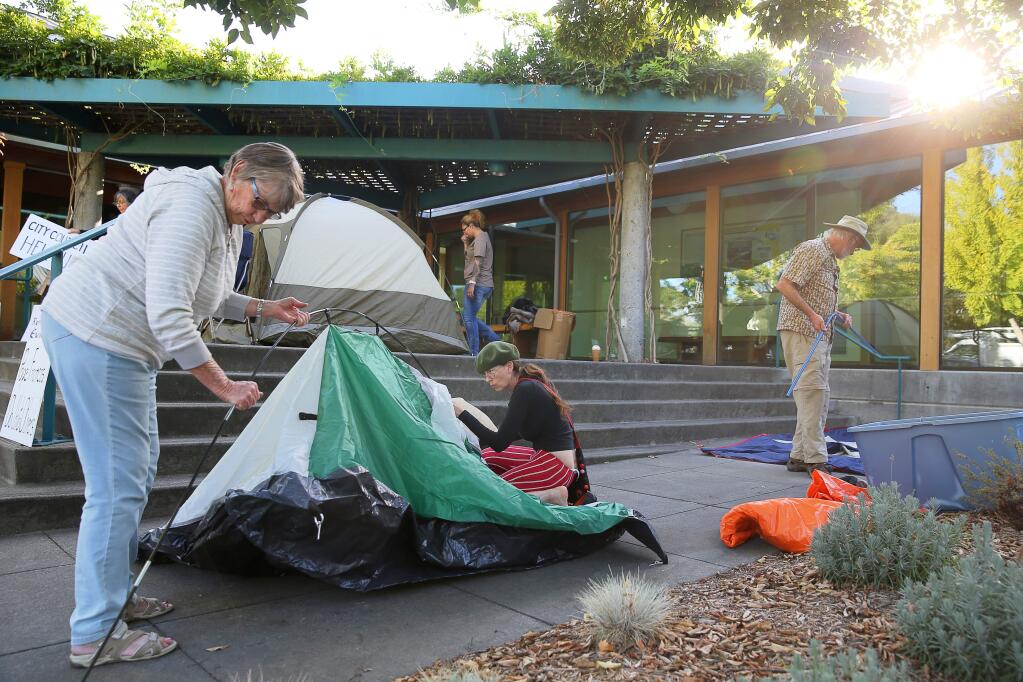 Sue McMillan, left, and Gwen Rosewater set up a tent in front of Healdsburg City Hall to protest rent hikes in Healdsburg on Monday, October 5, 2015. (Christopher Chung/ The Press Democrat)