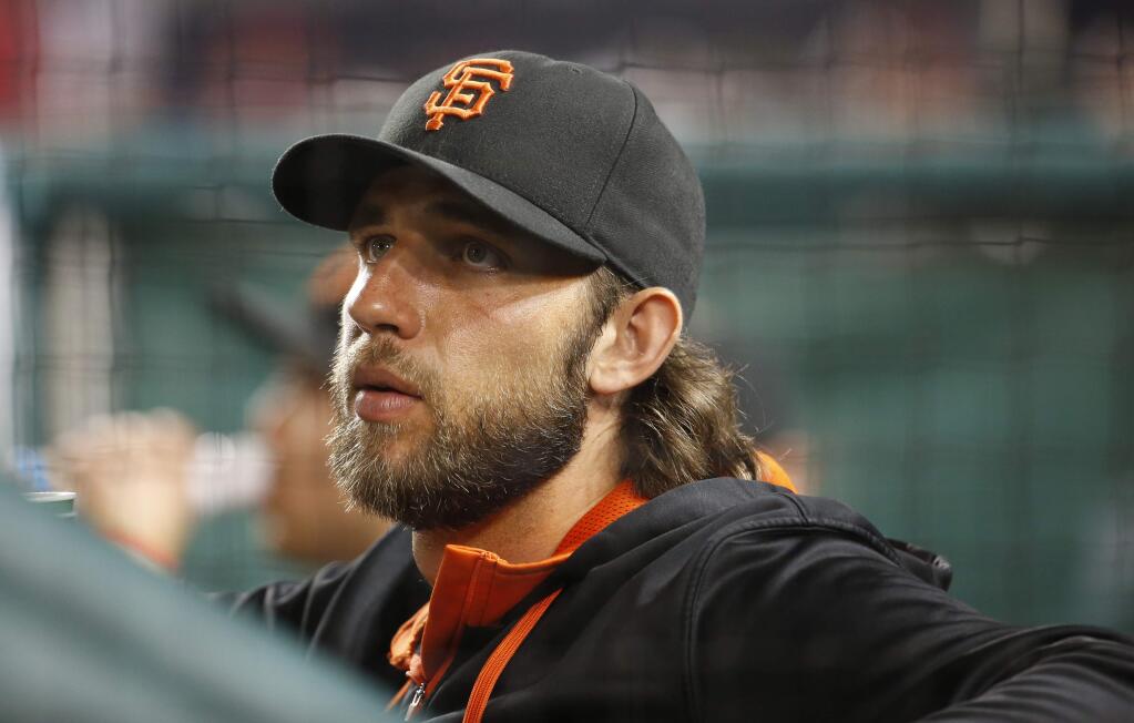 San Francisco Giants starting pitcher Madison Bumgarner (40) pauses in the dugout during a baseball game against the Washington Nationals at Nationals Park, Sunday, July 5, 2015, in Washington. (AP Photo/Alex Brandon)