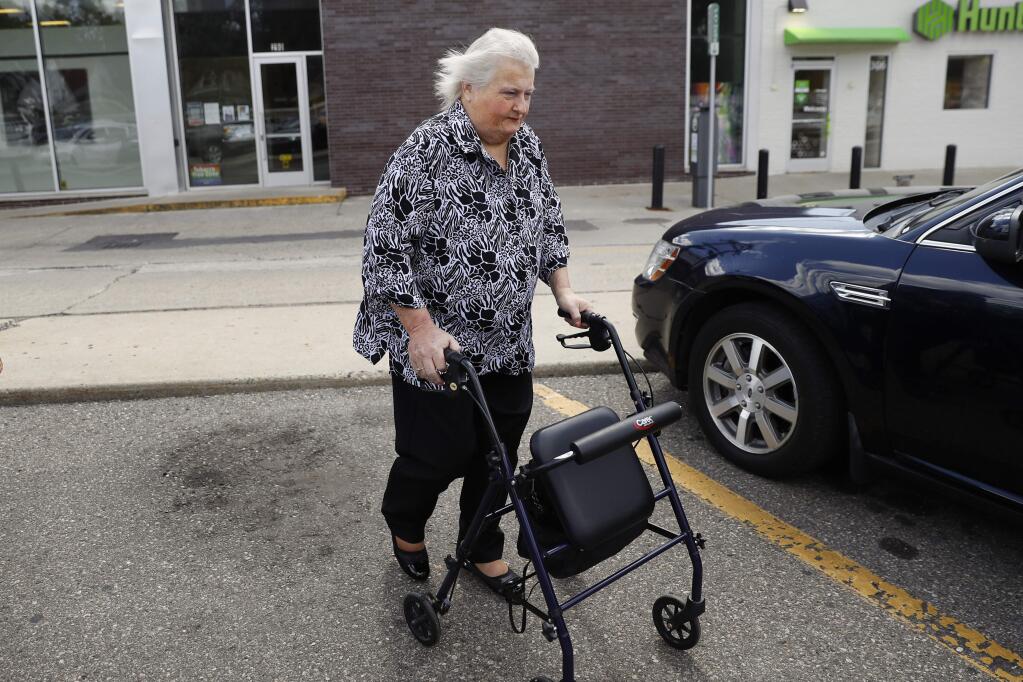 Aimee Stephens walks to her car in Ferndale, Mich., Wednesday, Aug. 28, 2019. The Supreme Court will hear Stephens' case Oct. 8 over whether federal civil rights law that bars job discrimination on the basis of sex protects transgender people. Other arguments that day deal with whether the same law covers sexual orientation. (AP Photo/Paul Sancya)