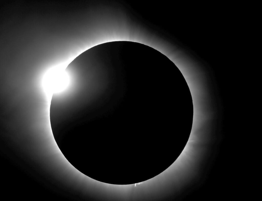 This photo provided by Bob Baer and Sarah Kovac, participants in the Citizen CATE Experiment, shows a 'diamond ring' shape during the 2016 total solar eclipse in Indonesia. For the 2017 eclipse over the United States, the National Science Foundation-funded movie project nicknamed Citizen CATE will have more than 200 volunteers trained and given special small telescopes and tripods to observe the sun at 68 locations in the exact same way. The thousands of images from the citizen-scientists will be combined for a movie of the usually hard-to-see sun‚Äôs edge. (R. Baer, S. Kovac/Citizen CATE Experiment via AP)