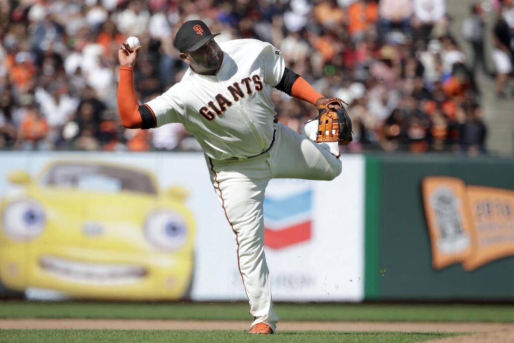 In this July 21, 2019, file photo, San Francisco Giants third baseman Pablo Sandoval throws to first base on an infield hit by the New York Mets' Todd Frazier during the 12th inning in San Francisco. The 33-year-old Sandoval is working back from season-ending Tommy John reconstructive surgery on his right elbow. (AP Photo/Jeff Chiu, File)