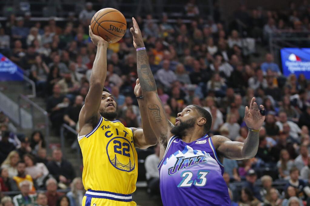 Golden State Warriors forward Glenn Robinson III shoots as Utah Jazz forward Royce O'Neale defends in the first half Friday, Nov. 22, 2019, in Salt Lake City. (AP Photo/Rick Bowmer)