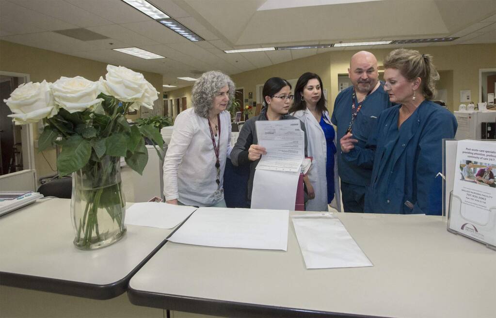 Reviewing patient goals and plan of care In the Skilled Nursing Facility at the Sonoma Valley Hospital are, from left, Helen Thompson, Activities Director, SNF; Aubrey Viesca, RN, MDS Coordinator, SNF; Marisol Sandoval, MS, SNF Intake Coordinator and Resource Discharge Planner,; Stan Greene, RN, SNF; Melissa Evans, RN, MSN, Director of Nursing, SNF. (Photo by Robbi Pengelly/Index-Tribune)