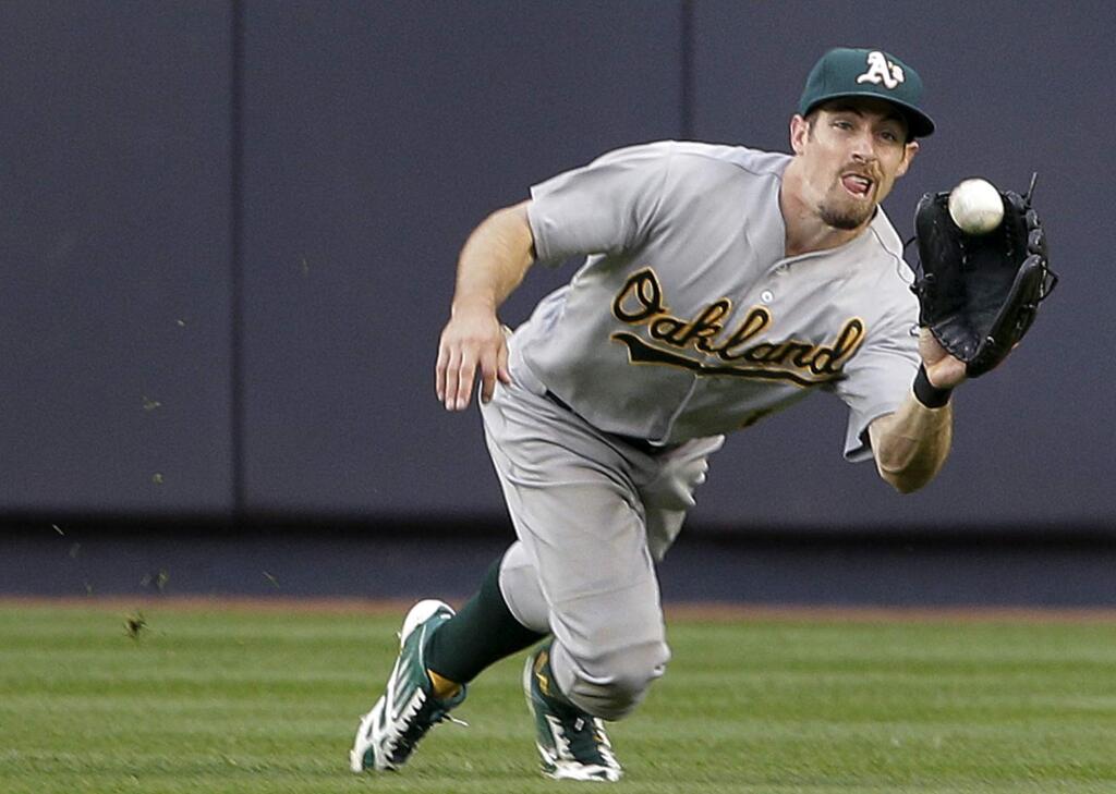 Oakland Athletics center fielder Billy Burns makes a lunging catch on a ball hit by New York Yankees' John Ryan Murphy during the third inning of a baseball game, Wednesday, July 8, 2015, in New York. (AP Photo/Julie Jacobson)