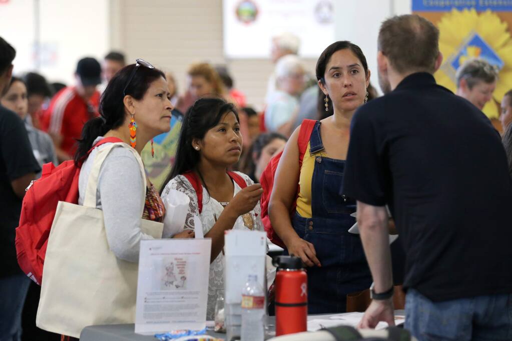 Irma Garcia, left, Cristina Ramirez, center, and Gabriela Orantes to Brian Branley of the American Red Cross speak during the Sonoma Ready Day event at the Sonoma County Fairgrounds in Santa Rosa on Sunday, September 8, 2019. (BETH SCHLANKER/ The Press Democrat)