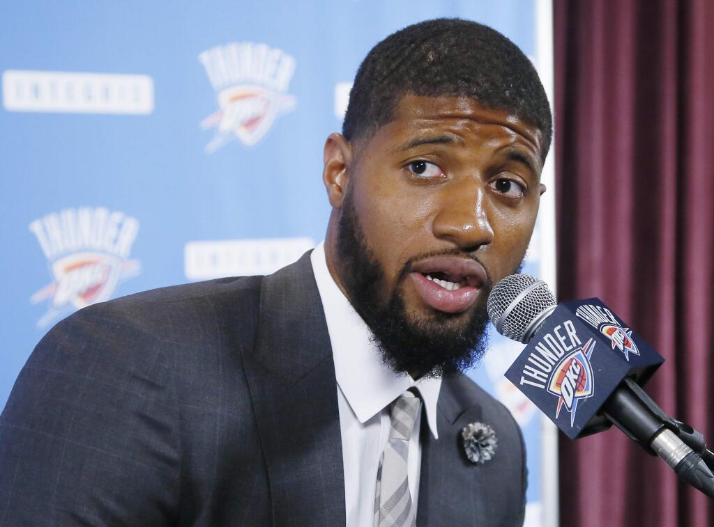 Oklahoma City Thunder forward Paul George answers a question at his first news conference since Oklahoma City's blockbuster trade with the Indiana Pacers, in Oklahoma City, Wednesday, July 12, 2017. (AP Photo/Sue Ogrocki)