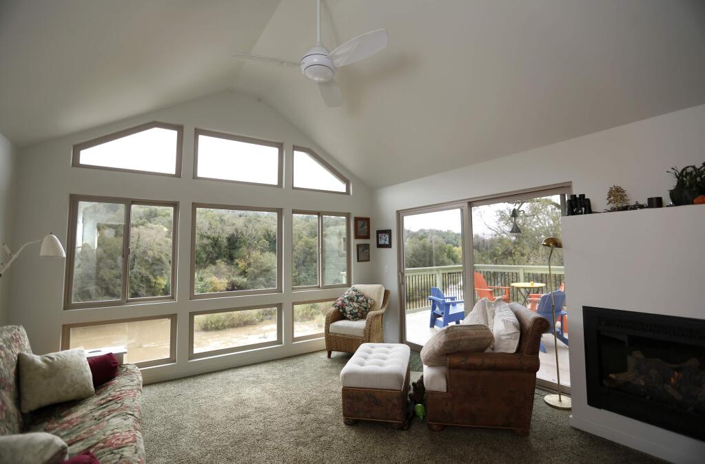 Betsy Sliney and her husband Matt Norelli built an enclosed room where their old deck used to be, soundproofed the walls, and put in all new windows throughout the house in order to reduce the noise from a vacation rental next door. Photo taken at their home in Healdsburg, on Sunday, November 20, 2016. (BETH SCHLANKER/ The Press Democrat)
