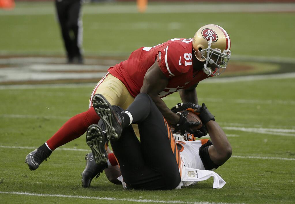 San Francisco 49ers wide receiver Anquan Boldin (81) is tackled by Cincinnati Bengals defensive end Carlos Dunlap before losing a fumble that Dunlap recovered during the first half of an NFL football game in Santa Clara, Calif., Sunday, Dec. 20, 2015. (AP Photo/Eric Risberg)