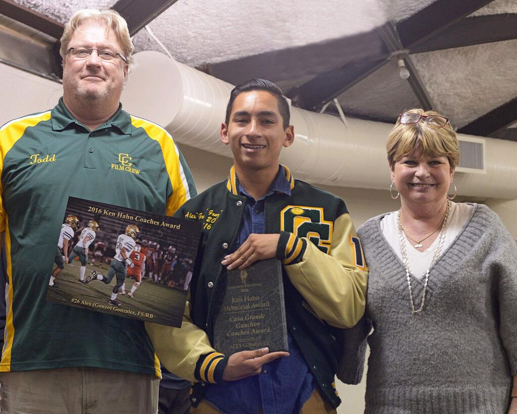 SUMNER FOWLER/FOR THE ARGUS-COURIERAlex Gonzalez was awarded the Ken Hahn Coach's Award at the Casa Grande Football Awards Dinner. Pictured with the player are Todd Anderson, close friend of the Casa videographer Hahn who passed away in 2015, and Hahn's partner, Gael Adair Grove.
