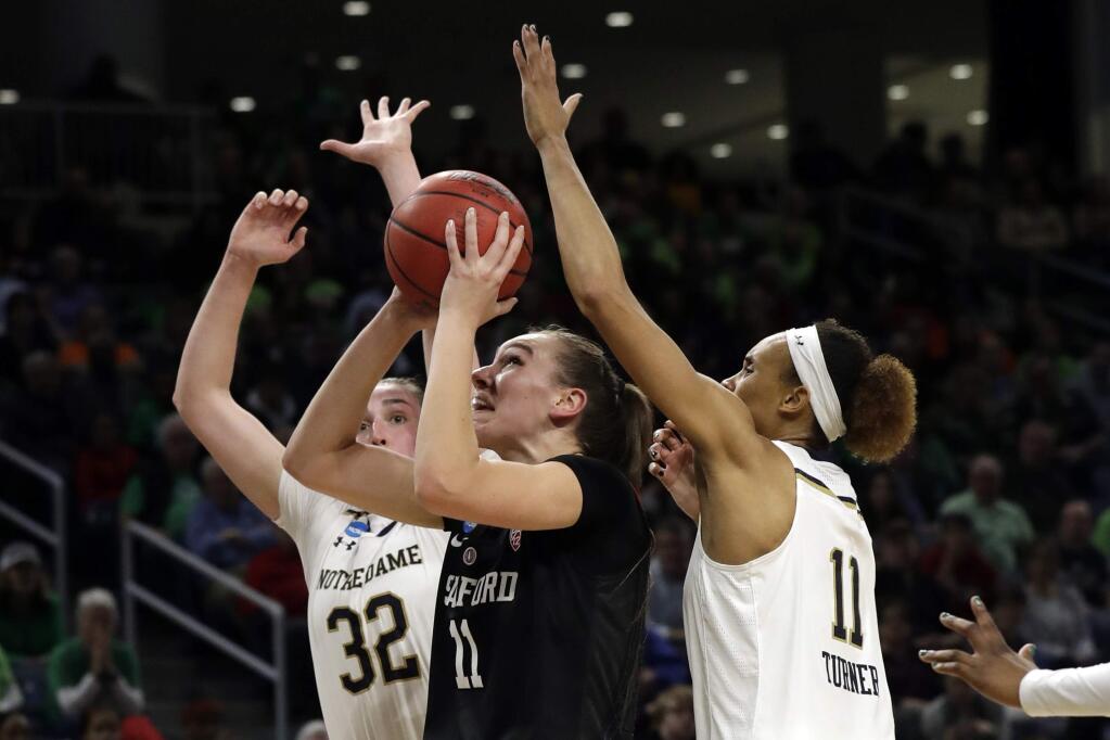 Stanford's Alanna Smith (11) shoots between Notre Dame's Jessica Shepard (32) and Brianna Turner (11) during the first half of a regional championship game in the NCAA women's college basketball tournament, Monday, April 1, 2019, in Chicago. (AP Photo/Nam Y. Huh)