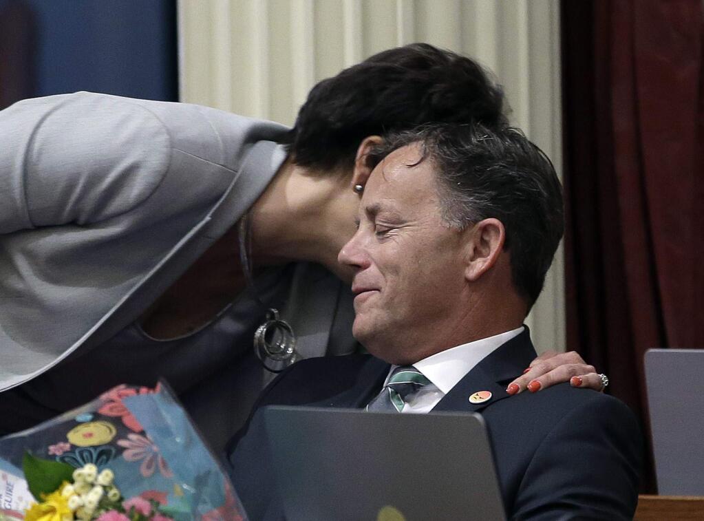 State Sen. Josh Newman, D-Fullerton, is hugged by Sen. Connie Leyva, D-Chino, after his remarks concerning the recall election against him, Monday, June 11, 2018, in Sacramento, Calif. Newman was recalled in last Tuesday's election and former Assemblywoman Ling Ling Chang, R-Diamond Bar, was voted in to replace him. (AP Photo/Rich Pedroncelli)