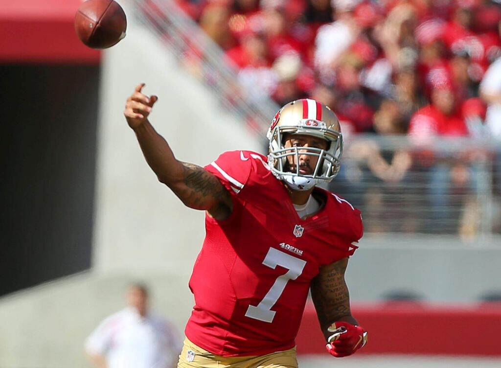 Colin Kaepernick throws a pass against the Baltimore Ravens during their game in Santa Clara last year. (Christopher Chung / The Press Democrat)