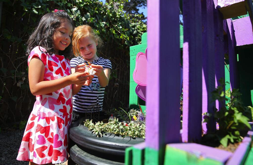 Kindergartners Natalie Padilla, left, and Elle Brackett play together in the STEM Garden at La Tercera Elementary School, in Petaluma, on Tuesday, September 6, 2016. (Christopher Chung/ The Press Democrat)
