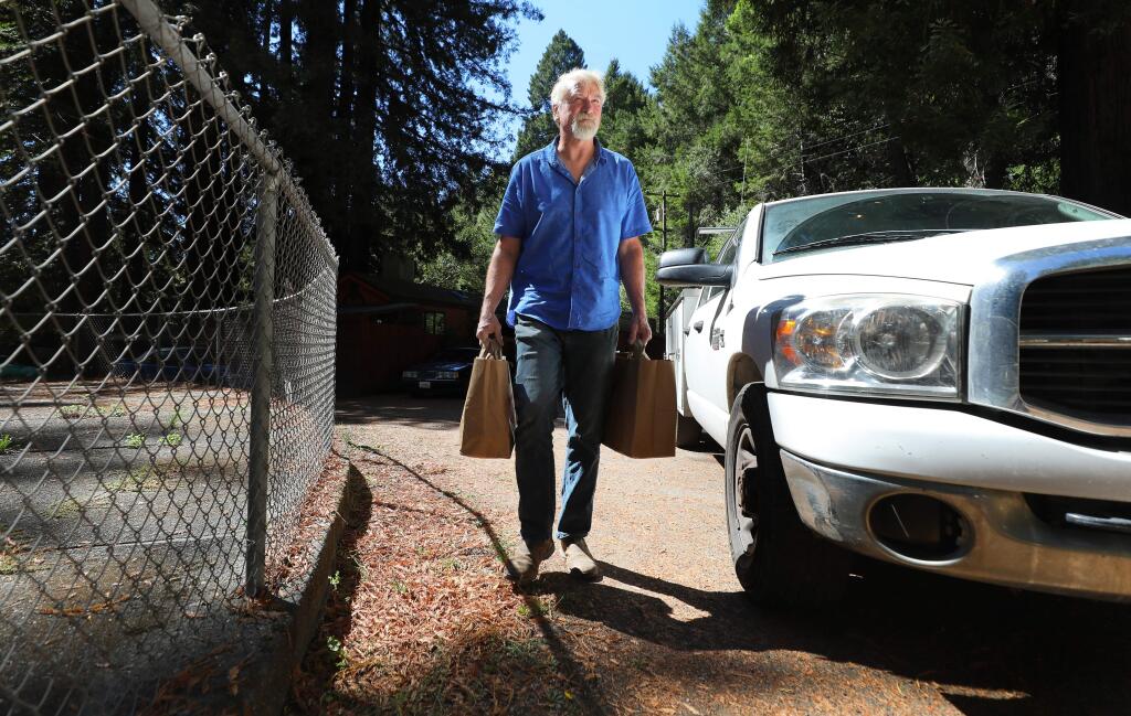Hunter Smith delivers groceries to a Food For Thought client in Guerneville on Tuesday, September 24, 2019. (Christopher Chung/ The Press Democrat)