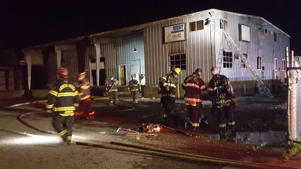 Santa Rosa firefighters at the scene of a fire inside an abandoned metal building in the 200 block of Roseland Avenue on Saturday, March 26, 2016. (ELOÍSA RUANO GONZÁLEZ/ PD)