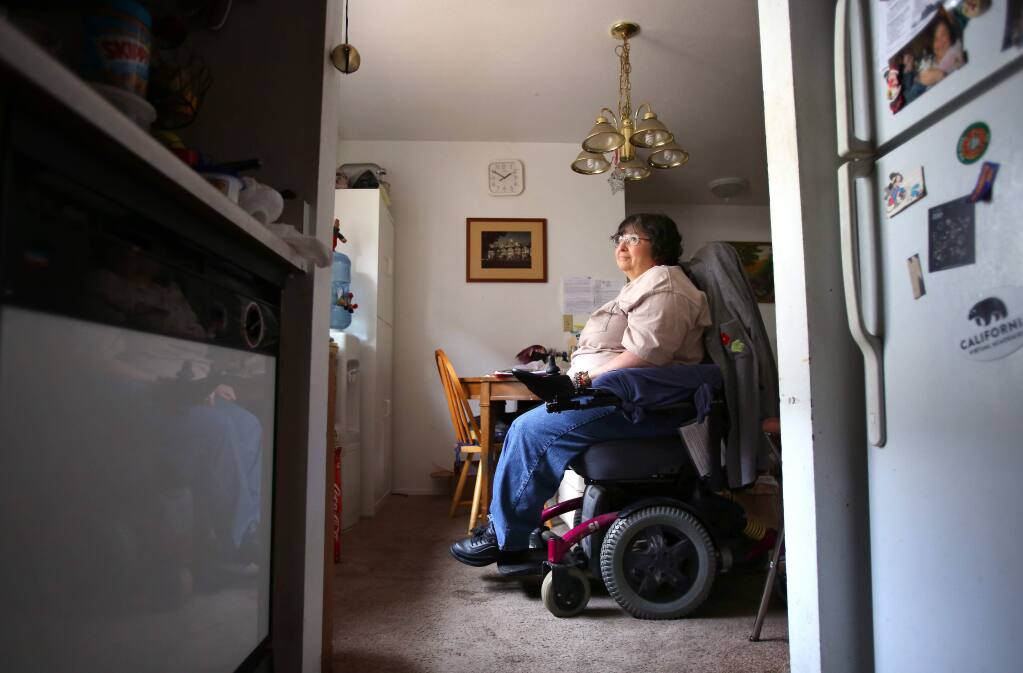 Kim Orellana, who is confined to a wheelchair and suffers from diabetes and multiple sclerosis, was told by the new owners of Casa de Sonoma apartments, where she lives with her daughter, Alicia, that she needs to move out by February so that the complex can be renovated. Orellana has lived in the apartment for six years, and has had trouble finding an affordable place to live in Sonoma.(Christopher Chung/ The Press Democrat)